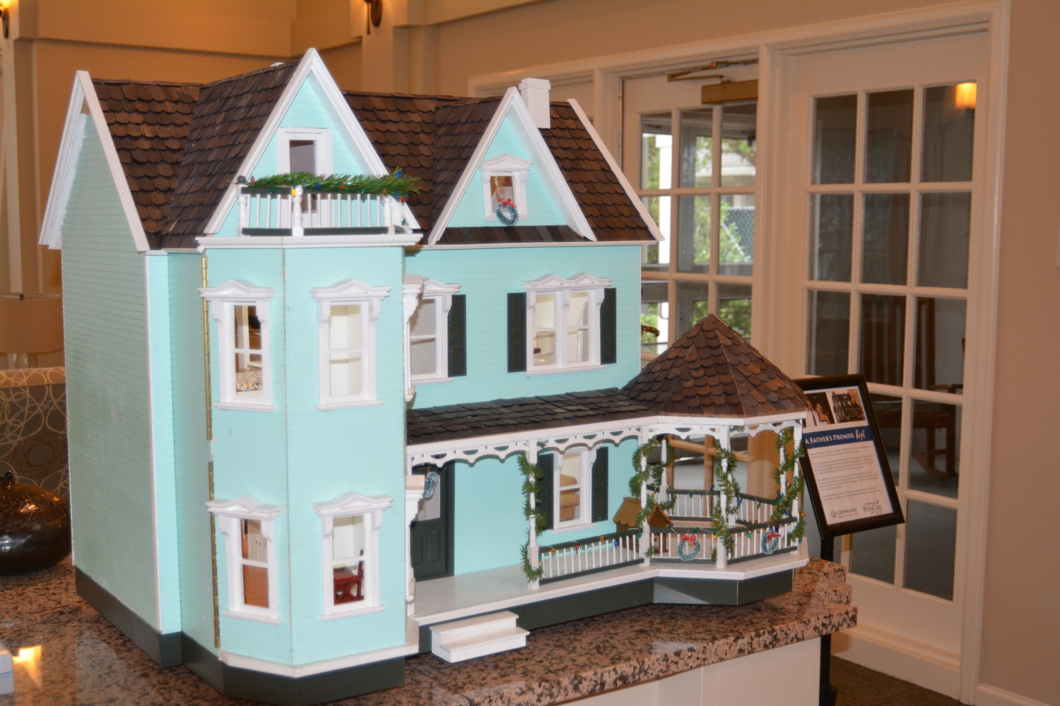 One of Hoffman's doll houses is displayed alongside his story in the lobby of Community Hospice & Palliative Care's Earl B. Hadlow Center for Caring in Jacksonville.